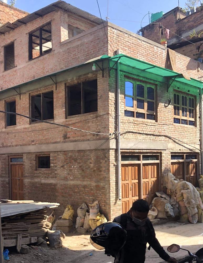 A finished three-story brick house